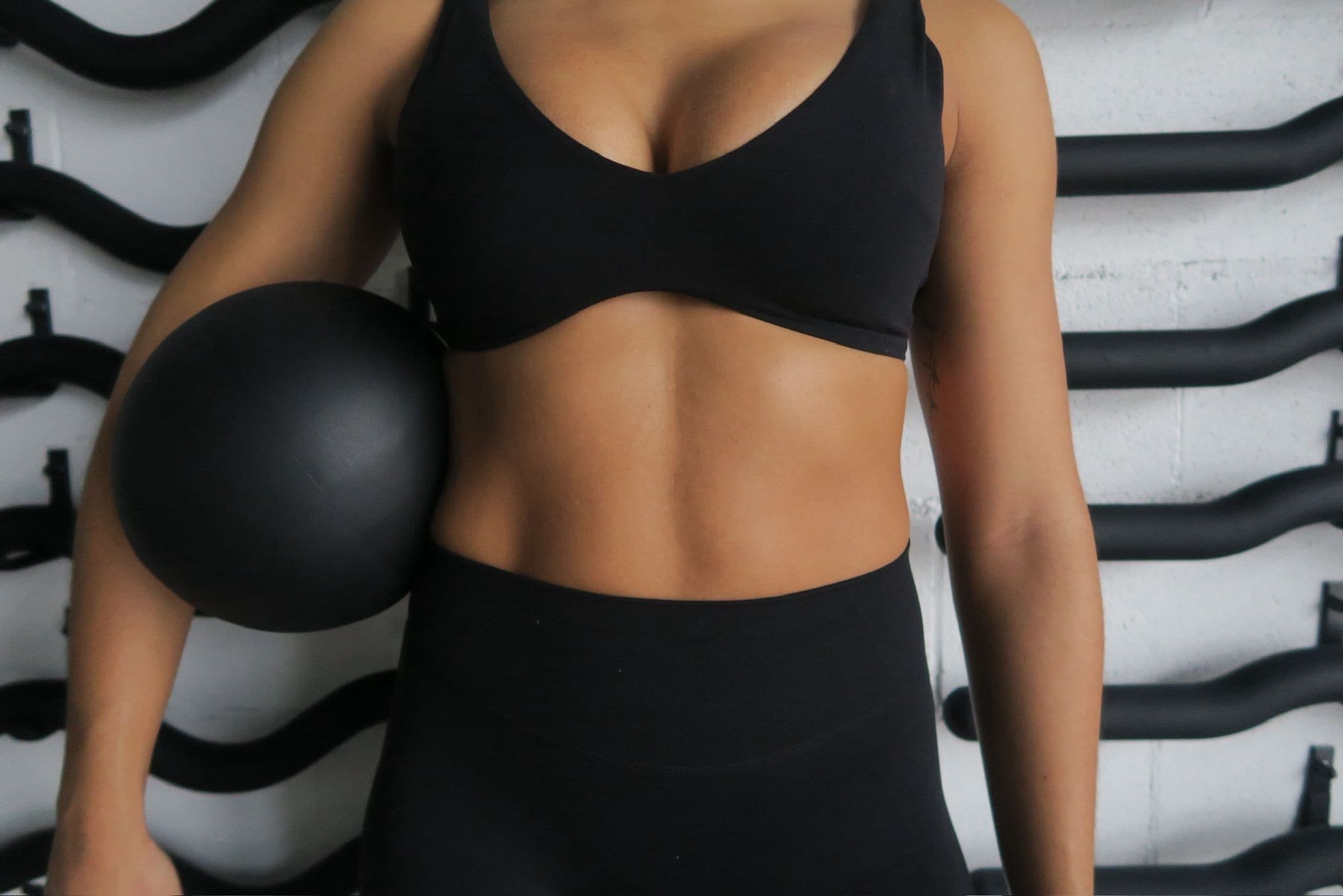 A member training one-on-one with a weighted ball at The Good Core studio
